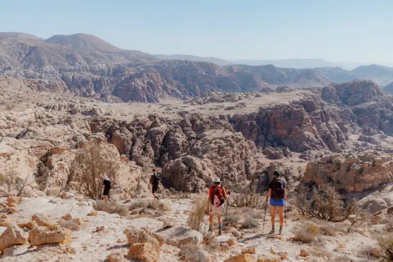 hikers on the Jordan Trail in a vast desert landscape