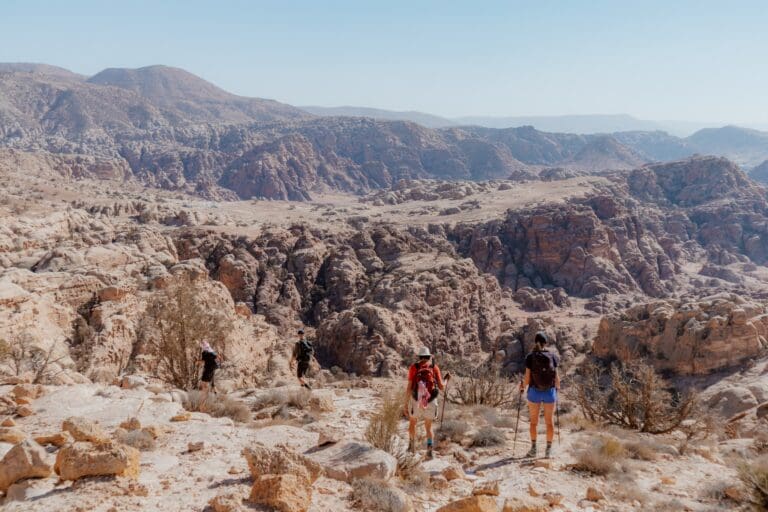 hikers on the Jordan Trail in a vast desert landscape
